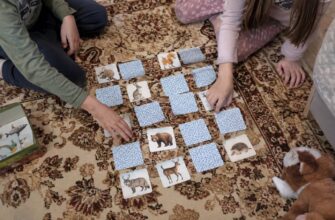 Children playing a matching-pairs game with animal cards