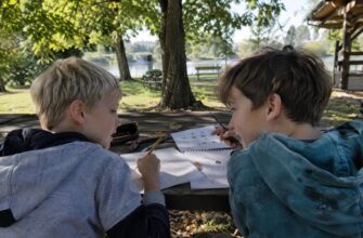 Children creating symbol codes at a park table