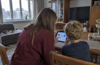 A parent and child discussing a tablet activity